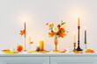 © Maya Kruchancova - beautiful autumn home decor with burning candles in white interior