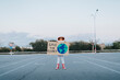 © VISTA by Westend61 - Girl dressed as astronaut showing Save The Planet cut out standing in parking lot