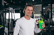 © Quality Stock Arts - healthy sport man with whey shaker bottle. happy drinking whey protein for muscle strength mass gain and low fat beverage meal in gym fitness