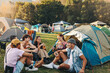 © Jacob Lund - Festival camp conversations: Group of youthful friends bond over beer and laughter
