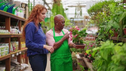 Wall Mural - Elderly Black Woman Assisting Customer in Horticulture Store. A Confident Senior Lady Guiding Plant Purchase at a Local Flower Shop