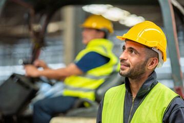 Portrait of forklift truck driver man smiling in old factory warehouse lifting pallet in storage shipping. forklift truck driver mail inside old forklift smiling to worker employee in warehouse store.