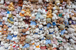 A large pile of multicolored teddy bears toys as a background texture
