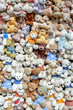 A large pile of multicolored teddy bears toys as a background texture