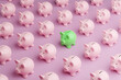© Dragon Claws - Green piggy bank among rows of pink piggy banks. Illustration of the concept of correct and profitable investment
