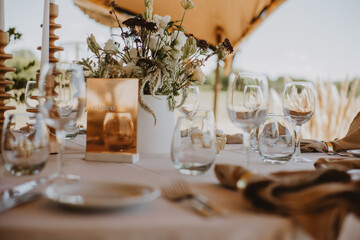 Wall Mural - table setting with cup of wine, candles and flowers in a wedding