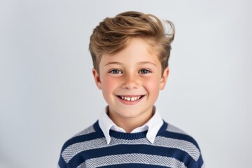 Wall Mural - Portrait of a smiling little boy on a white background. Copy space.