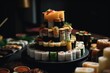 Huge tiered cake made of sushi rolls. Table and catering full of Asian Japanese food.