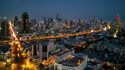 Poster - Aerial view of Bangkok Downtown skyline, highway roads or street in Thailand. Financial district and business area in smart urban city. Skyscraper and high-rise buildings at night.