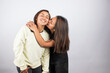 © artrolopzimages - Portrait of two young women embracing on a white studio background. Concept of people.