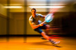 © aicandy - An out-of-focus shot of a racquetball player in action, providing a unique artistic perspective of the game
