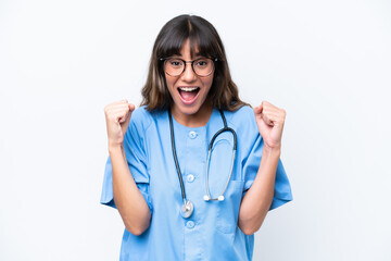 Young caucasian nurse woman isolated on white background celebrating a victory in winner position