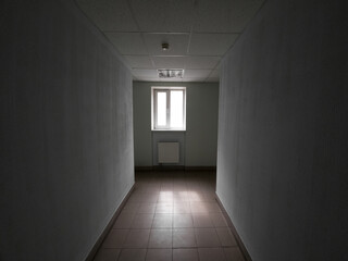 Wall Mural - empty dark office corridor with window in the end