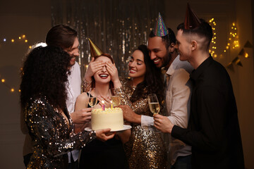 Canvas Print - Happy friends with tasty cake and glasses of sparkling wine celebrating birthday indoors