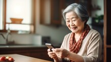 Senior Japanese Women Looking At Smartphone Screens With A Smile.