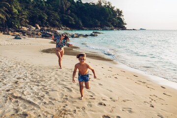 Sticker - Toddler and mother running on the beach 