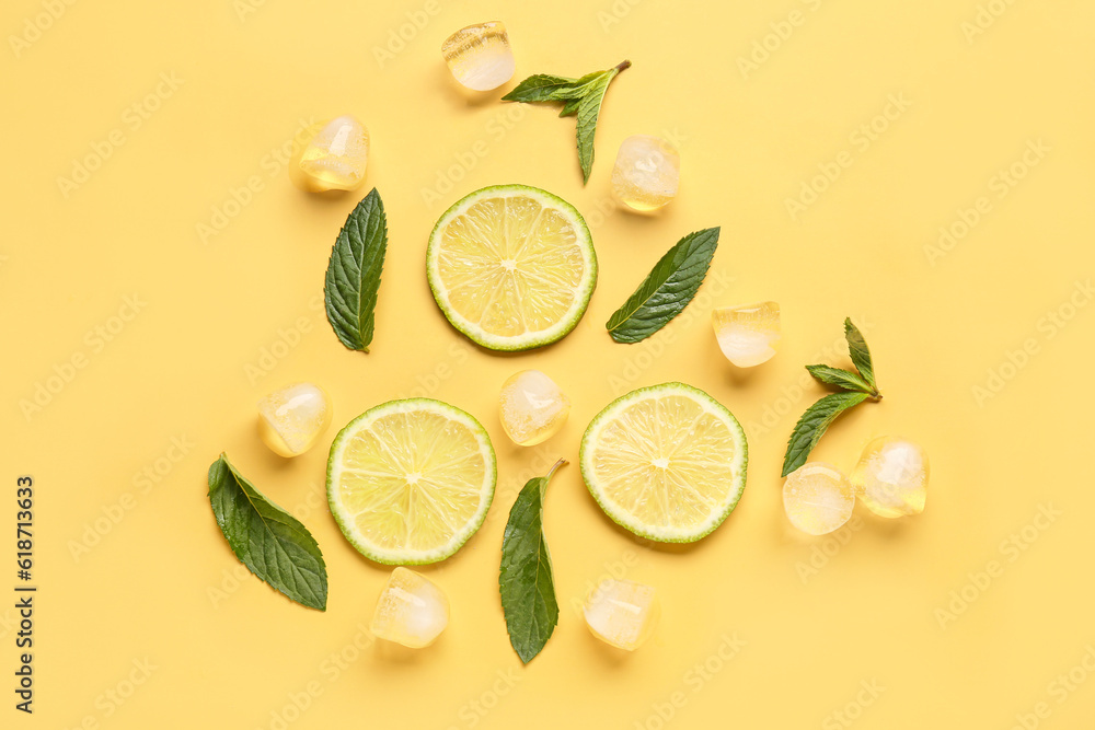 Lime slices with ice cubes and mint on orange background