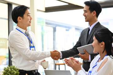 Two smiling business men in the office, finishing meeting, congratulation, startup, teamwork and trust