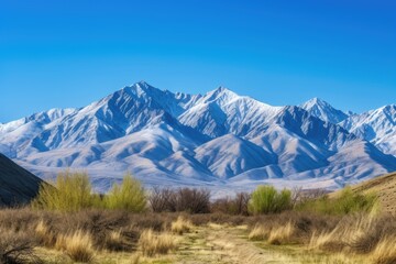 Wall Mural - majestic mountain range surrounded by clear blue skies, created with generative ai