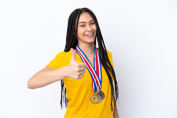 Poster - Teenager girl with braids and medals over isolated pink background with thumbs up because something good has happened