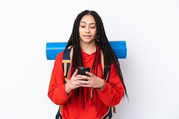 Poster - Hiker teenager girl with braids over isolated white background sending a message with the mobile