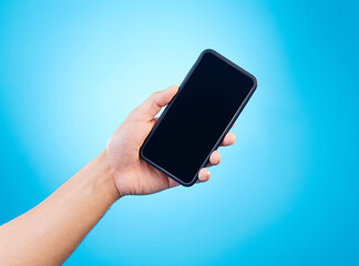 Poster - Mockup, blue background and hand with phone in studio for mobile app, website and social media. Advertising, marketing and isolated person holding smartphone for promotion, branding and information