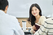 © TEAM PRE-LIGHT - Male and female university students looking backwards talking or discussing during class or studying in a lecture hall at a Korean university in Asia.