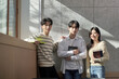 © TEAM PRE-LIGHT - Model of a young male and female college student couple leaning against the wall of a university lecture hall in a light-filled room in South Korea, Asia.