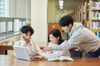 © TEAM PRE-LIGHT - Two young college student man and woman couple model and solo male model looking at laptop and book together in library of Asian Korean university
