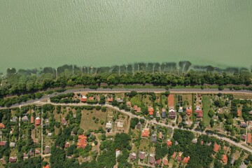 Sticker - an aerial view of a small town with a very long road