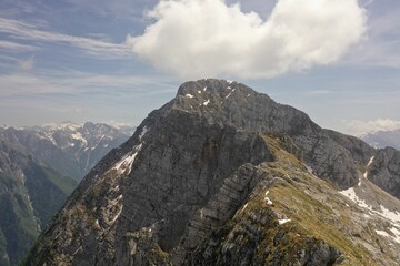 Sticker - a large mountain top with snow on it and a cloud in the sky