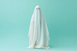 © Magryt - White ghost on pastel background. Minimal Halloween scary concept. Ghost sheet Halloween costume. Minimalist composition with copy space. AI generated