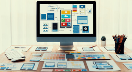 Digital and paper wireframe designs for web or mobile app UI UX display on laptop computer screen. Panoramic shot of developer workspace for brainstorming and design application framework. Scrutinize