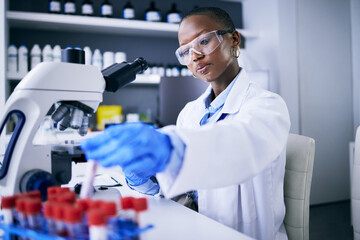 blood test, microscope and science woman in laboratory for cancer research, medical analysis and dna
