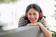 © wichayada - Young asian woman with headphones relaxing at home. listening to music. sitting on cozy sofa wearing headphone