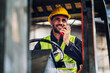 © kanpisut - Man worker at forklift driver happy working in industry factory logistic ship. Man forklift driver in warehouse area. Forklift driver sitting in vehicle in warehouse.