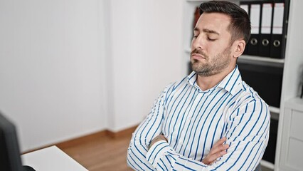 Wall Mural - Young hispanic man business worker tired working at office