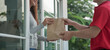 Happy smiling Asian woman receives paper bag parcel of food from courier front house. Delivery man send deliver express. online shopping, paper container, takeaway, postman, delivery service, packages
