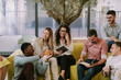 © qunica.com - Black male business person joking with his senior Caucasian colleague while he is looking at his notebook. He is also giving him an applause. Everybody's laughing