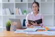 © Tj - Sharing good business news. Attractive young businesswoman talking on the mobile phone and smiling while sitting at her working place in office.