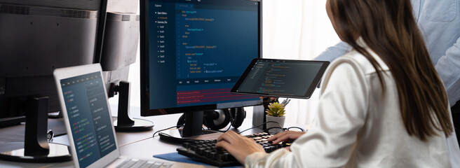 Wall Mural - software development team working together in office, coding script display on computer monitor. pro