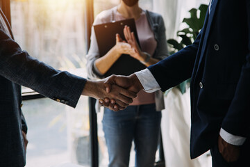 Business handshake for teamwork of business merger and acquisition,successful negotiate,hand shake,two businessman shake hand with partner to celebration partnership and business deal concept