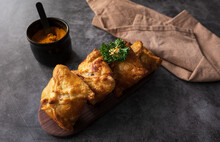 Close Up Of Traditional Kazakh And Central Asian Cuisine Concept. Samsa Or Samosa Or Sambousak On A Plate. Samsa Or Samosa Is An Oriental Meal To Be Stuffed With Minced Meat, Cheese Or Vegetables.