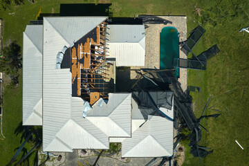 Poster - Hurricane Ian destroyed house roof in Florida residential area. Natural disaster and its consequences