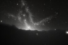 A Black And White Photo Of A Night Sky With Stars And A Mountain In The Distance With A Bright Light In The Middle Of The Sky And A Few Stars In The Middle Of The Sky.