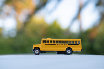 Sticker - Small model of american yellow school bus as symbol of education in the USA