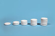 © Branislava - Effervescent tablets stack on a pastel blue background