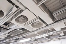 ventilation system with vents and fans in ceiling of warehouse or factory, providing fresh air and removing odors, created with generative ai