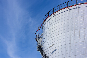Wall Mural - Oil storage tanks with blue sky background, Industrial tanks for petrol and oil, White fuel storage tank against blue sky.