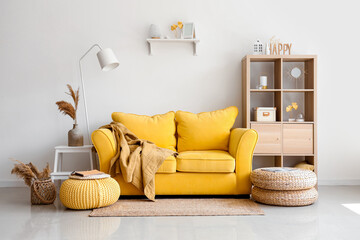 Sticker - Interior of light living room with stylish yellow sofa and soft poufs